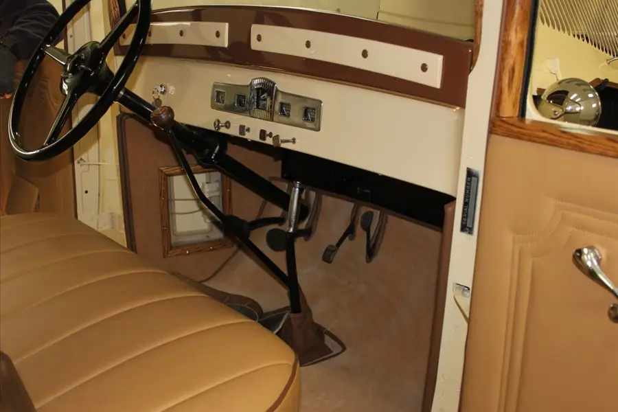 A restored vintage dashboard, warm wood and gauges.