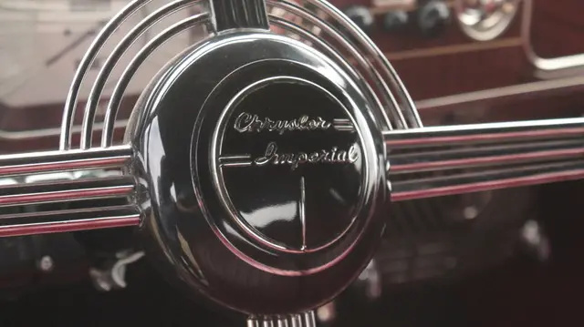 A restored Chrysler steering wheel, shallow-focus emblem.
