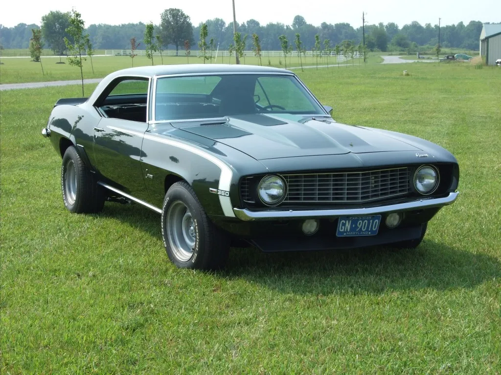 A dark-green first-generation Camaro with a stock body and modern drivetrain