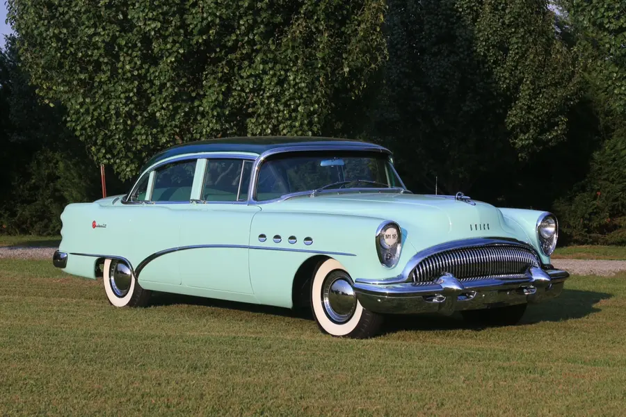 A mint restored sedan, three-quarter glamour view in warm light.