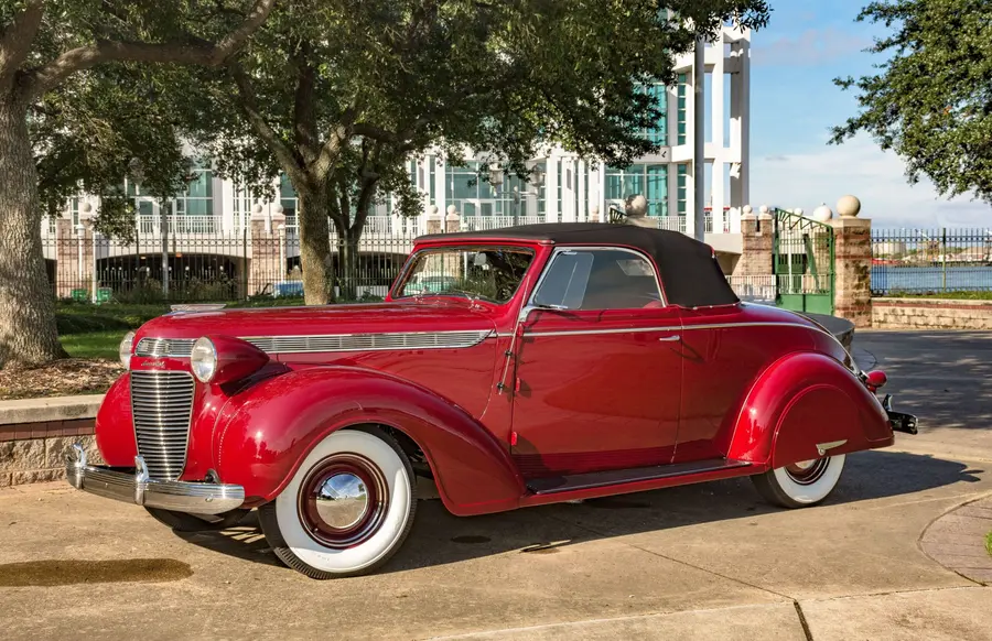 1937 Chrysler Imperial roadster &ldquo;Black Betty&rdquo; in deep red, side profile.