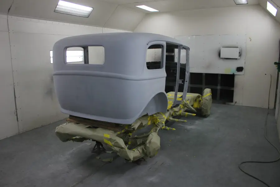 A stripped classic body in the shop paint booth.